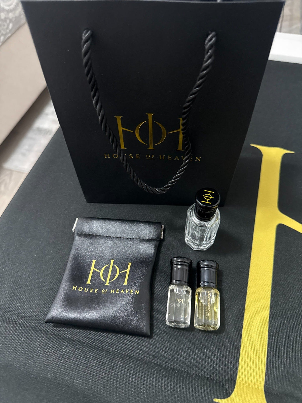 Imagine House of Heaven real product photo with fragrance bottles, pouch and bag